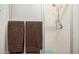 Walk-in shower with tiled walls, shower head, and two dark brown towels hanging at 2277 N Recker Rd # 6, Mesa, AZ 85215