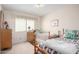 Bright bedroom with twin beds, dresser, and window, offering a cozy and inviting space at 2277 N Recker Rd # 6, Mesa, AZ 85215