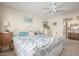 Comfortable bedroom with ceiling fan, and an ensuite bathroom featuring natural wood cabinets at 2277 N Recker Rd # 6, Mesa, AZ 85215