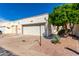 Exterior featuring a one car garage, desert landscaping, and a view of the community at 2277 N Recker Rd # 6, Mesa, AZ 85215