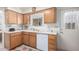 Kitchen with stainless steel appliances, natural wood cabinets, tile flooring, and lots of natural light at 2277 N Recker Rd # 6, Mesa, AZ 85215