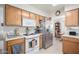 Bright kitchen featuring stainless steel appliances and natural wood cabinets at 2277 N Recker Rd # 6, Mesa, AZ 85215