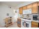 Bright kitchen featuring white appliances, natural wood cabinets, and tile flooring at 2277 N Recker Rd # 6, Mesa, AZ 85215