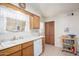 Bright kitchen featuring white appliances, natural wood cabinets, and a window with lots of natural light at 2277 N Recker Rd # 6, Mesa, AZ 85215