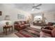 Comfortable living room featuring a sofa, recliners, area rug, and a ceiling fan at 2277 N Recker Rd # 6, Mesa, AZ 85215