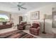Bright living room with ceiling fan, neutral walls, a sofa, and two recliners at 2277 N Recker Rd # 6, Mesa, AZ 85215