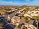 An aerial view shows this well-maintained desert home nestled among other homes in a vibrant community at 23005 N 19Th Way, Phoenix, AZ 85024