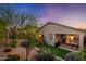 Picturesque backyard featuring a playset, covered patio, and desert landscaping at sunset at 23005 N 19Th Way, Phoenix, AZ 85024