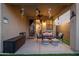 Covered patio with outdoor seating and decor, complemented by lush artificial grass at 23005 N 19Th Way, Phoenix, AZ 85024