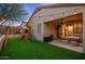 Beautiful backyard with artificial grass, a covered patio, string lights, and a playset at 23005 N 19Th Way, Phoenix, AZ 85024
