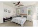 A bright bedroom with a ceiling fan, two windows, and a cozy bench adds character to the space at 23005 N 19Th Way, Phoenix, AZ 85024