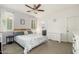 Cozy bedroom with a ceiling fan, two windows, and neutral decor for a relaxing ambiance at 23005 N 19Th Way, Phoenix, AZ 85024