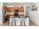 Stylish kitchen island features granite countertops, stainless sink, and barstool seating at 23005 N 19Th Way, Phoenix, AZ 85024
