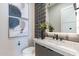 Stylish powder room featuring modern finishes including art, vanity, and a unique backsplash at 23656 N 123Rd St # 240, Scottsdale, AZ 85255