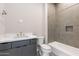 Modern bathroom featuring a gray vanity, marble countertop, and a bathtub with tile surround at 23656 N 123Rd St # 240, Scottsdale, AZ 85255