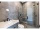 Modern bathroom featuring a marble vanity and glass-enclosed shower with hexagon tile at 23656 N 123Rd St # 240, Scottsdale, AZ 85255