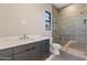 Modern bathroom featuring a gray vanity, marble countertop, and a walk-in shower with gray tile surround at 23656 N 123Rd St # 240, Scottsdale, AZ 85255