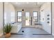 Bright bathroom featuring glass-enclosed shower, soaking tub, and an exterior view of desert landscaping at 23656 N 123Rd St # 240, Scottsdale, AZ 85255