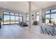 Open bedroom with large windows offering scenic views; two sitting areas with accent rugs at 23656 N 123Rd St # 240, Scottsdale, AZ 85255