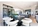 Bright dining area with modern table, white chairs, and open concept layout near kitchen and sliding glass doors at 23656 N 123Rd St # 240, Scottsdale, AZ 85255
