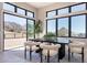 Dining area with a sleek black table, stylish chairs, and large windows showcasing desert landscape at 23656 N 123Rd St # 240, Scottsdale, AZ 85255