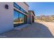 Exterior shot of the home showcasing the sliding glass doors and desert landscaping at 23656 N 123Rd St # 240, Scottsdale, AZ 85255