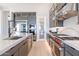 An open kitchen boasts stainless steel appliances, a large island, and a professional-grade gas range with a stainless hood at 23656 N 123Rd St # 240, Scottsdale, AZ 85255