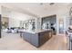 A luxurious kitchen with a large island overlooks a living area with modern fireplace and expansive sliding glass doors at 23656 N 123Rd St # 240, Scottsdale, AZ 85255
