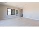 Spacious living room with light wood floors and views through black-framed windows at 23656 N 123Rd St # 240, Scottsdale, AZ 85255