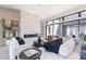 Elegant living room featuring a modern fireplace, white sofas, leather chairs, and sleek black coffee table at 23656 N 123Rd St # 240, Scottsdale, AZ 85255
