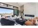 Bright living room features modern fireplace, stylish furniture, and large sliding glass doors with picturesque mountain views at 23656 N 123Rd St # 240, Scottsdale, AZ 85255