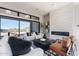 Bright living room featuring modern fireplace, sliding glass doors with views, and comfortable seating arrangement at 23656 N 123Rd St # 240, Scottsdale, AZ 85255