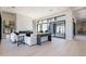 Bright living room boasts a modern fireplace, stylish furniture, and a large sliding glass door to the patio at 23656 N 123Rd St # 240, Scottsdale, AZ 85255