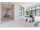 Open office space with large windows, leading to other parts of the home at 23656 N 123Rd St # 240, Scottsdale, AZ 85255