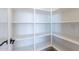 The bright pantry features white shelves for organization at 23656 N 123Rd St # 240, Scottsdale, AZ 85255