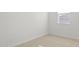 Bright bedroom with neutral carpet, white walls, and a window, creating a serene space at 23972 W Cocopah St, Buckeye, AZ 85326