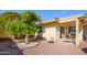 The backyard has desert landscaping, covered patio with furniture and a privacy wall at 25850 S Foxglenn Dr, Sun Lakes, AZ 85248