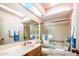 Bright bathroom with a tub, shower, large mirror, and skylight at 25850 S Foxglenn Dr, Sun Lakes, AZ 85248