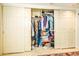 A closet with a variety of hanging clothes and stored items on shelves at 25850 S Foxglenn Dr, Sun Lakes, AZ 85248