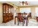 Dining area showcasing tile floors, dining table set, a traditional china cabinet, and unique glass block window at 25850 S Foxglenn Dr, Sun Lakes, AZ 85248