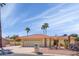 Charming single-story home featuring a well-manicured desert landscape and a red tile roof under a sunny sky at 25850 S Foxglenn Dr, Sun Lakes, AZ 85248