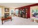 Comfortable living room with a fireplace, large entertainment center, plush seating, and well-lit from natural light at 25850 S Foxglenn Dr, Sun Lakes, AZ 85248
