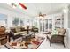 Bright living room with decorative ceilings, ceiling fans, tiled flooring, and comfortable wicker furniture at 25850 S Foxglenn Dr, Sun Lakes, AZ 85248