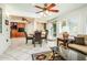Bright living room with decorative ceilings, ceiling fans, tile flooring, and comfortable wicker furniture at 25850 S Foxglenn Dr, Sun Lakes, AZ 85248