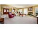 Spacious living room featuring a fireplace, comfortable seating arrangements, and an open transition to other living areas at 25850 S Foxglenn Dr, Sun Lakes, AZ 85248