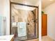Modern tiled shower with glass doors, shower head and seat fixture at 25850 S Foxglenn Dr, Sun Lakes, AZ 85248