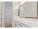 Bright bathroom featuring a framed mirror above a white vanity, with a shower-tub combo at 2606 E Virginia Cir, Mesa, AZ 85213