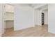 Clean and simple bedroom with walk-in closet and wood-look tile flooring at 2606 E Virginia Cir, Mesa, AZ 85213