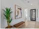 Inviting entryway with neutral tones, modern art, and beautiful wood-look tile flooring throughout at 2606 E Virginia Cir, Mesa, AZ 85213