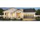 Inviting exterior displaying a two-story home with stone accents, neutral colors, and a charming front porch at 2606 E Virginia Cir, Mesa, AZ 85213